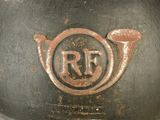 a close up of a metal bowl with a red emblem on it