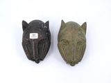 pair of carved animal heads on a white background