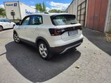 the rear end of a white volkswagen suv parked in a parking lot
