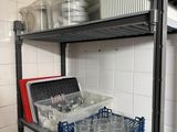 a shelf with many containers and containers on it in a kitchen