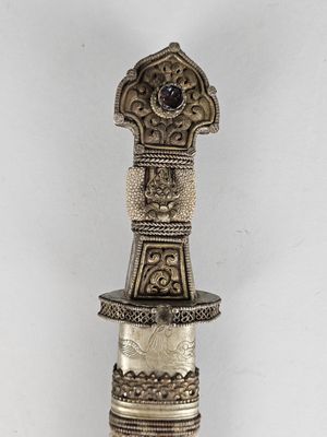 an image of a silver and black object on a white surface