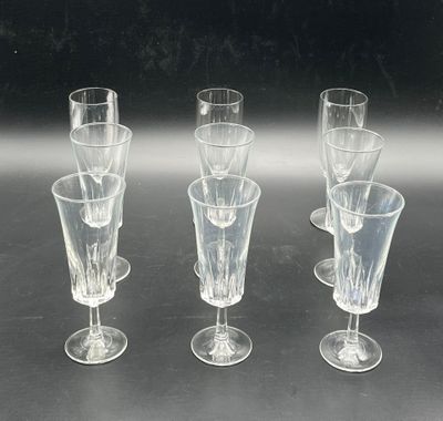 four wine glasses sitting on a table next to each other