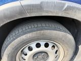 a close up of a flat tire on a blue truck