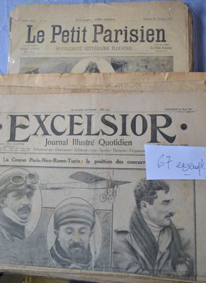 several old newspapers are stacked on top of each other on a table