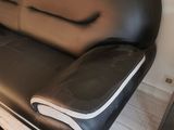 a black and white leather couch and ottoman in a living room