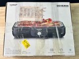 packaging for a black and decker electric roaster on a wooden table
