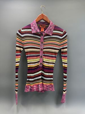 un pull coloré suspendu à un cintre contre un mur
