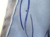 close up of a piece of fabric with a blue design on it