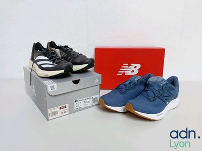 two new balance shoes in a box next to a pair of new balance shoes