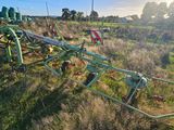 a tractor that is sitting in the grass in the field
