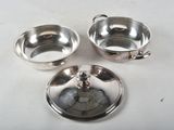 four pieces of silverware sitting on a white table top