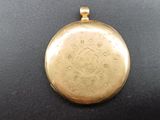 an image of a gold locke on a black surface