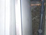 an image of a refrigerator in a dirty room