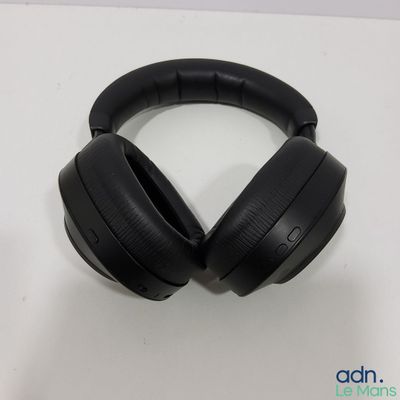 an image of a pair of black headphones sitting on top of a table