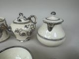 several different types of teapots and cups on a table