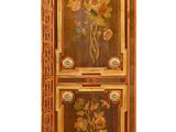 a tall cabinet with flowers painted on it