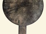 a large round metal object with a handle on it