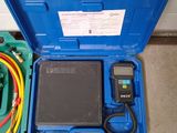 a blue case with wires and a meter in it