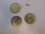 three different coins are shown on a white surface with a price tag