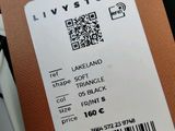 a tag that says live stone on it next to a laptop