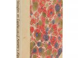 un vieux livre à la couverture rouge, orné de fleurs bleues et vertes