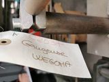 a sign on a piece of paper hanging from a machine