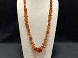 a necklace made of raw baltic amber beads on a mannequin