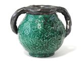 a green vase with a black handle on a white background