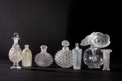 many different glass bottles sitting on a black surface