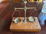 a wooden table with a metal scale on top of it