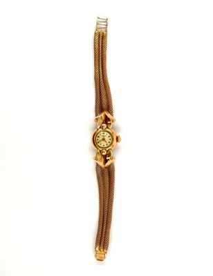 an image of a gold watch with a chain around it
