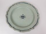 a blue and white plate with a picture of a tree on it