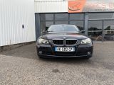 a picture of a black bmw car parked in front of a building