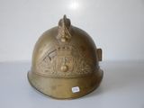 an old brass helmet with a crown on top