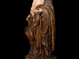 an image of a statue of jesus holding a baby on a black background