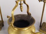 a gold pot with a handle on a white table