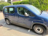 a blue van that is parked in a parking lot