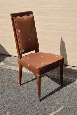 a brown chair sitting in front of a white wall