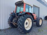 a tractor that is parked in front of a building