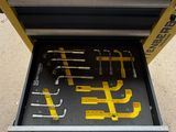 a drawer with tools inside of it on the ground
