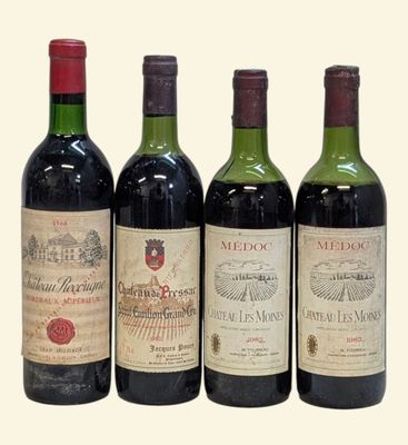 three bottles of red wine are lined up on a white surface