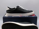 a pair of black and white sneakers sitting on top of a box