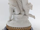 a statue of a boy and a girl on a pedestal
