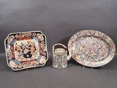 three pieces of chinese porcelain on display on a table