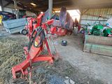 a red machine that is sitting in the dirt