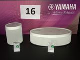 two white speakers sitting next to each other on a table
