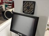 a monitor mounted on the wall in a room