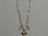 a gold and pearl necklace with a cross pendant
