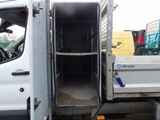 a white truck with its door open in a parking lot