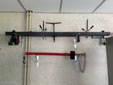 a rack with tools hanging from it on the wall